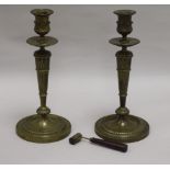A pair of bronze candlesticks together with French candle snuffer height 26cm