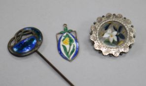 An early 20th century Art Nouveau silver and enamel hat pin, a silver and enamel pendant and a