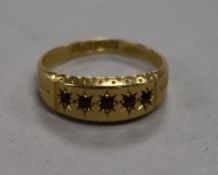 An Edwardian 18ct gold and gem set half hoop ring, size M.