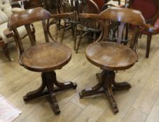 A pair of oak barber's chairs