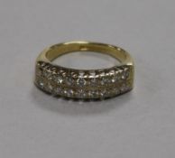 An 18ct gold and twin row diamond half hoop ring (one stone missing), size K.