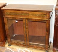A Regency rosewood low bookcase, inlaid with cut brasswork, enclosed by a pair of glazed doors W.