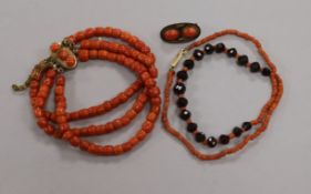 A triple strand coral bead bracelet with French silver mark, a coral and facetted bead necklace