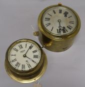 A brass ship's bulkhead clock and another by Smith, each with white Roman dial
