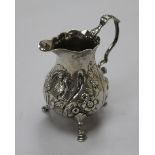 A George III silver cream jug, with later embossed decoration, London, 1762, 10cm.