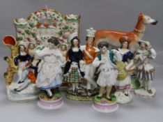 A collection of Staffordshire flatbacks and two bisque figures tallest 27cm