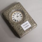 A late Victorian repousse silver travelling watch case, with pocket watch, Henry Matthews,