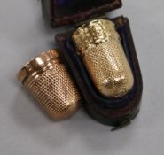 An early 20th century 9ct gold thimble and a cased yellow metal thimble.