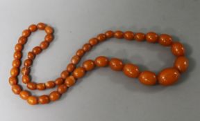 A single strand reconstituted? amber necklace, 66cm