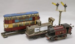 An A & J Van Riemsdyk clockwork train and track and two toy train engines longest 24cm