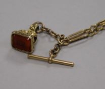 An early 20th century 18ct gold albert chain and a gold overlaid fob seal with carnelian matrix.