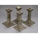 A set of four plated candlesticks height 15cm