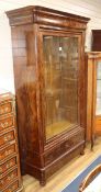 A 19th century French feathered mahogany bookcase, enclosed by a single glazed door W.109cm approx.