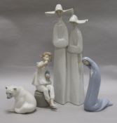 A tall Lladro group of two nuns, glazed in white and three other Lladro figures, including Girl with