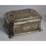 An early 20th century continental Arts & Crafts embossed white metal casket, on shell feet, 19cm, 24