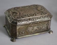 An early 20th century continental Arts & Crafts embossed white metal casket, on shell feet, 19cm, 24