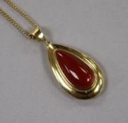 An Italian 18ct gold and pear shaped coral drop pendant, on an 18ct gold chain, gross 7 grams,