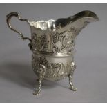 An Edwardian embossed silver cream jug, Williams Ltd, Birmingham, 1904, height 95mm.