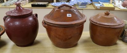 Three late Victorian terracotta cream pans, with wooden covers tallest 33cm