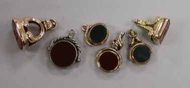 A Victorian 9ct gold and bloodstone fob seal, two other yellow metal seals and three other seals.