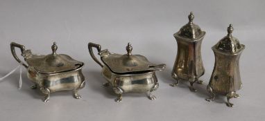 A George V silver four piece condiment set by Walker & Hall, Birmingham, 1921 and three associated