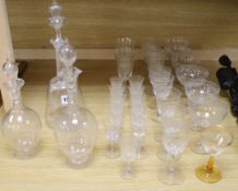 Three Edwardian etched glass decanters and mixed similar suites of glasses tallest 32cm