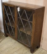 A 1940's oak glazed bookcase W.92cm