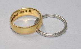 An 18ct gold wedding band and a platinum wedding ring.