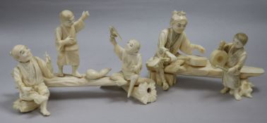 Two Japanese sectional ivory groups of figures on benches, early 20th century,