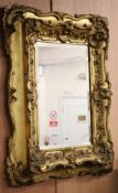 A late Victorian carved gilt wood ''picture'' framed mirror W.71cm