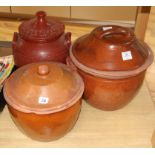 Three late Victorian terracotta cream pans, with wooden covers tallest 33cm