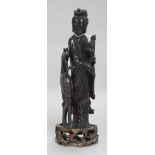 A Chinese faux amber standing figure of Xi Wangmu with a phoenix, wood stand, 23.5cm