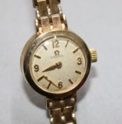 A lady's Omega 9ct gold wristwatch fitted a brick-link bracelet (loose hand).