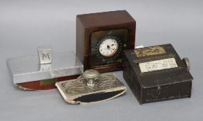 A metal address book, clocking in clock and two blotters