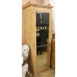 A pine single wardrobe with mirrored door W.56cm