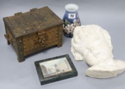 A plaster wall mount of a cherub's face, a metal box, a B + G vase and a print inset in marble