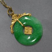 A yellow metal mounted jade disc pendant on 9ct gold fine chain 25mm.