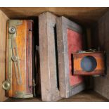 An early 20th century mahogany and brass bellows camera with three various lenses including an