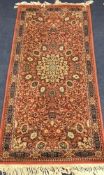 An orange ground Persian rug 75 x 90cm