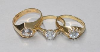 Three assorted 9ct gold and cubic zirconia dress rings, gross 9.3 grams.