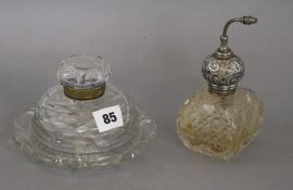 A silver mounted cut glass atomiser and a glass inkwell