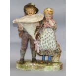 A Continental pottery group of a boy and girl height 46cm