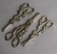 A pair of modern silver grape shears and two pairs of silver plated grape shears.