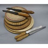 Five carved bread boards plus four carved handled bread knives largest diameter 30cm