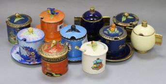 Eight Carlton Ware drum-shaped preserve jars and five stands, various designs and two Art Deco