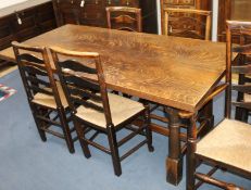 An oak refectory style dining table having plank top with turned supports on H-stretcher W.175cm