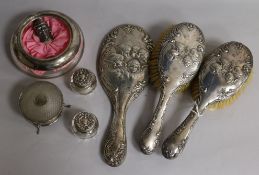 An Edwardian three piece silver brush and mirror set with Reynolds Angel decoration, a George V