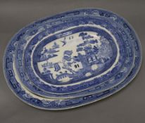 A graduated set of three Wedgwood blue and white Willow pattern meat dishes (largest chipped)