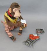 A 1930's novelty bottle opener and a mechanical monkey