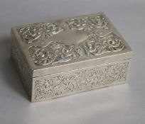A late Victorian silver cigarette box with embossed and chased foliate decoration, London 1891 5.